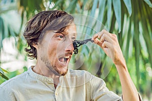 Happy man with black mask on the face. Photo of man receiving spa treatments. Beauty Skin care concept