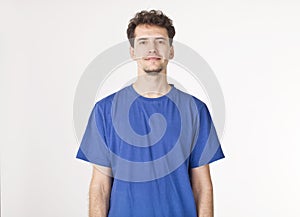 Happy man in blue studio shot, isolated