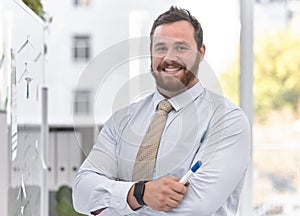 Happy man, board or portrait of teacher in classroom with arms crossed in business school, college or university