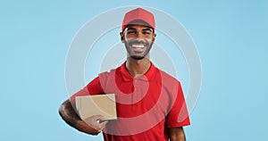 Happy man, box and delivery in transport service, package or order in studio against a blue background. Portrait of male