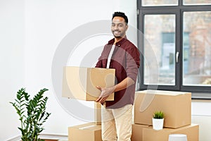 Happy man with box moving to new home