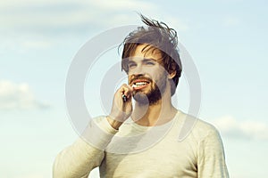 Happy man brush teeth with toothpaste on blue sky, metrosexual