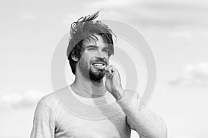 Happy man brush teeth with toothpaste on blue sky, metrosexual photo