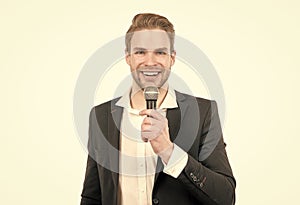 Happy man in business formalwear speak into microphone giving speech isolated on white, conferencier