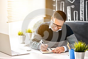 Happy man businessman, freelancer, student working at computer a