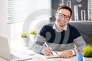 Happy man businessman, freelancer, student working at computer a