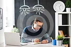 Happy man businessman, freelancer, student working at computer a