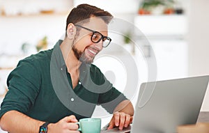 Happy man businessman, freelancer, student working at computer a