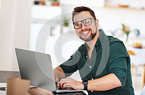 Happy man businessman, freelancer, student working at computer a photo