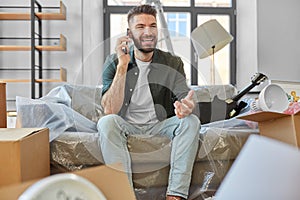 happy man calling on smartphone moving to new home