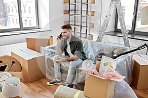 happy man calling on smartphone moving to new home