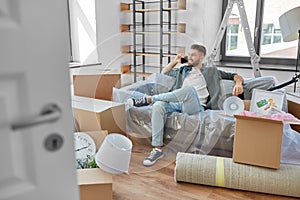 happy man calling on smartphone moving to new home