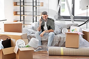 happy man calling on smartphone moving to new home