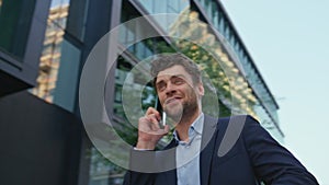 Happy man calling street modern residential area close up. Businessman talking