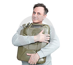 Happy man in casual clothes clutches an old iron canister of gasoline, isolated on a white background