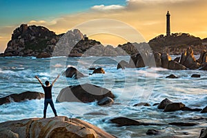 A Happy Man Celebrating Victory on The Top of A Big Rock by The Ocean