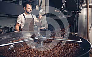 Happy man checking preparing coffee grains