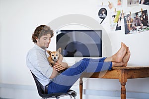 Happy man, computer screen or relax with dog and feet on table or technology mock up for online publisher. Young guy