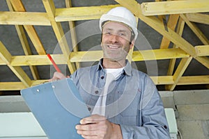 Happy man construction worker smiling while holdin