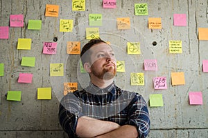 Happy man crossed arm with sticky notes