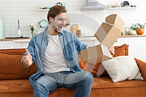 Happy man customer unpacking cardboard box receive open post mail delivery package