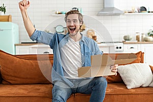 Happy man customer unpacking cardboard box receive open post mail delivery package