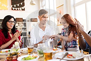 Happy man doing proposal to woman at restaurant