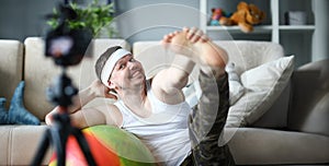 Happy Man Doing Stretching on Fitness Ball at Home