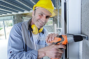 happy man drill at construction site
