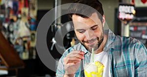 Happy man drinking milkshake