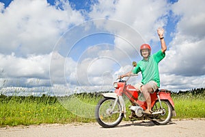 Happy man driving a moped