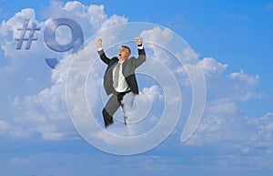 Happy man elated smiling with arms up floating on cloud nine