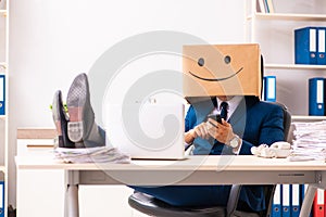 The happy man employee with box instead of his head