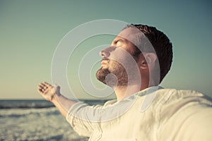 Happy man enjoying life at the beach