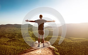 Happy man faces landscape with forest