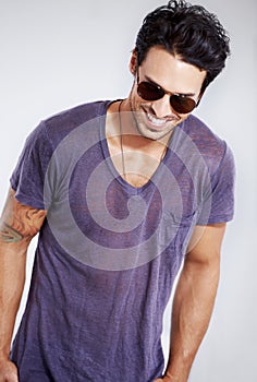 Happy, man and fashion with sunglasses in studio with confidence in clothes, cool style and pride. Summer, holiday and