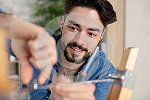 Happy man fixing screw window limite photo