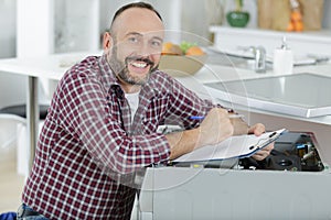 happy man fixing washing machine