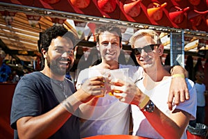Happy man, friends and cheers at music festival, bar or event for summer party or DJ concert. Portrait of male person or