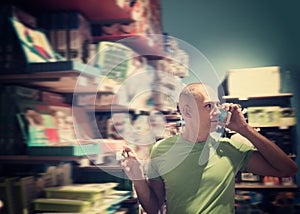 Happy man in front of difficult choice in store