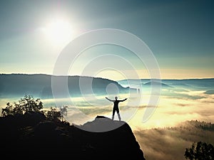 Happy man gesture of triumph with hands in the air. Funny hiker with raised arm