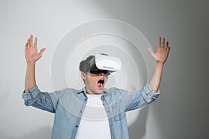 Happy man getting experience using VR headset glasses of virtual reality, isolated on white background