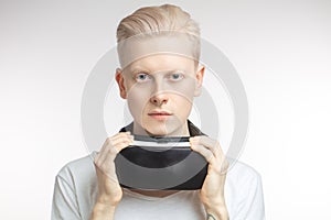 Happy man getting experience using VR headset glasses of virtual reality, isolated on white background