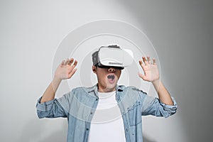 Happy man getting experience using VR headset glasses of virtual reality,  on white background
