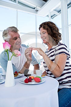 Happy man gifting ring to woman