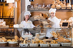 Happy man and girl selling pastry and loaves