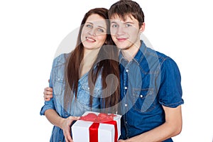 Happy Man giving a gift to his Girlfriend. Happy Young beautiful Couple isolated on a White background.