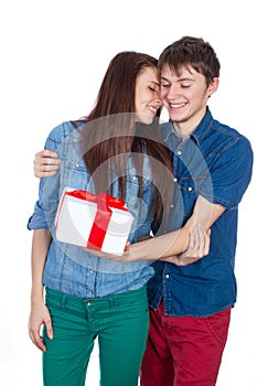 Happy Man giving a gift to his Girlfriend. Happy Young beautiful Couple isolated on a White background.