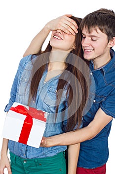 Happy Man giving a gift to his Girlfriend. Happy Young beautiful Couple isolated on a White background.