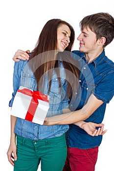 Happy Man giving a gift to his Girlfriend. Happy Young beautiful Couple isolated on a White background.